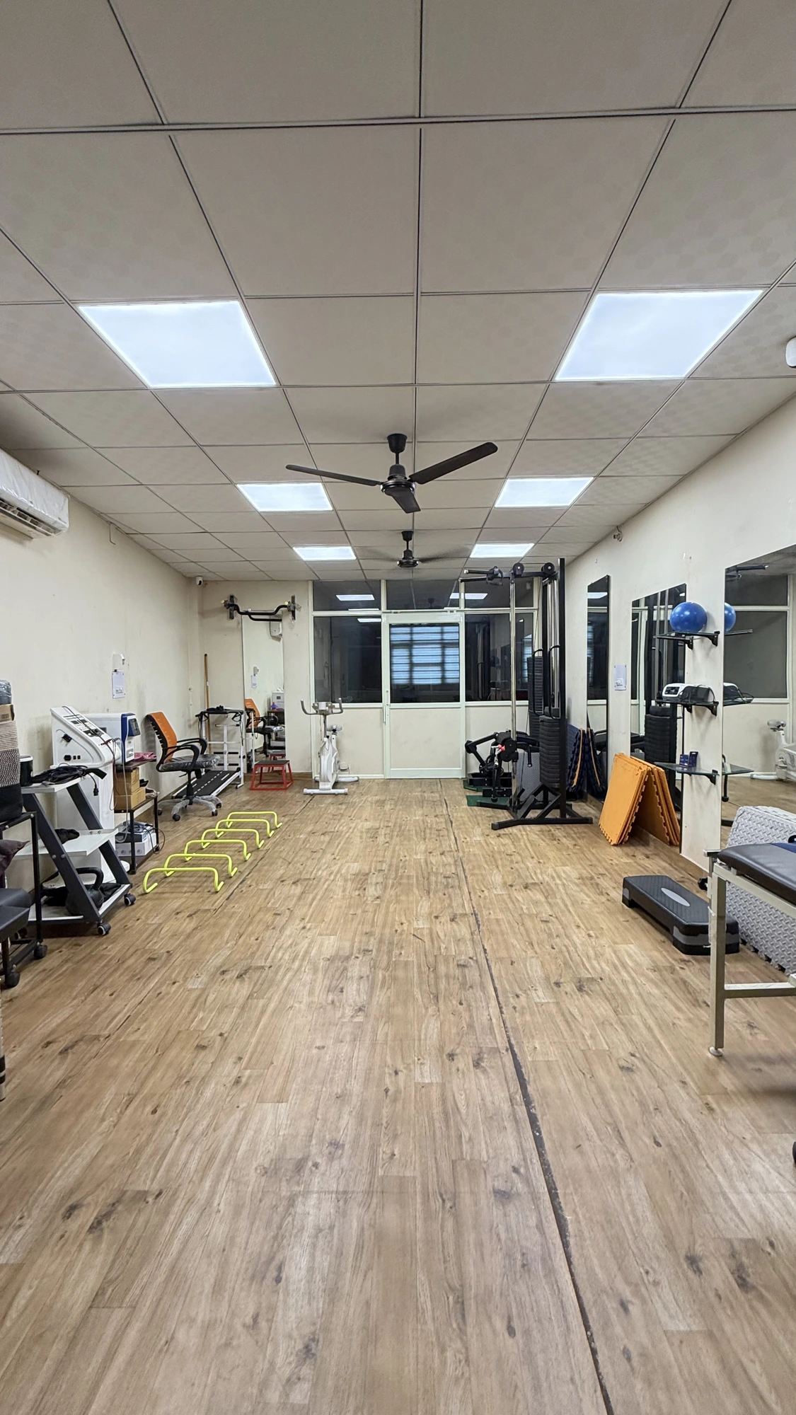 Strength and conditioning area at Physio Hyve Clinic with cable machine, treadmill and exercise cycle