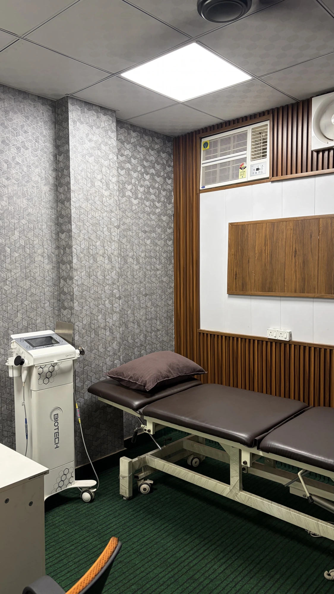 Private physiotherapy treatment room at Physio Hyve Clinic with adjustable treatment couch and TECAR therapy unit